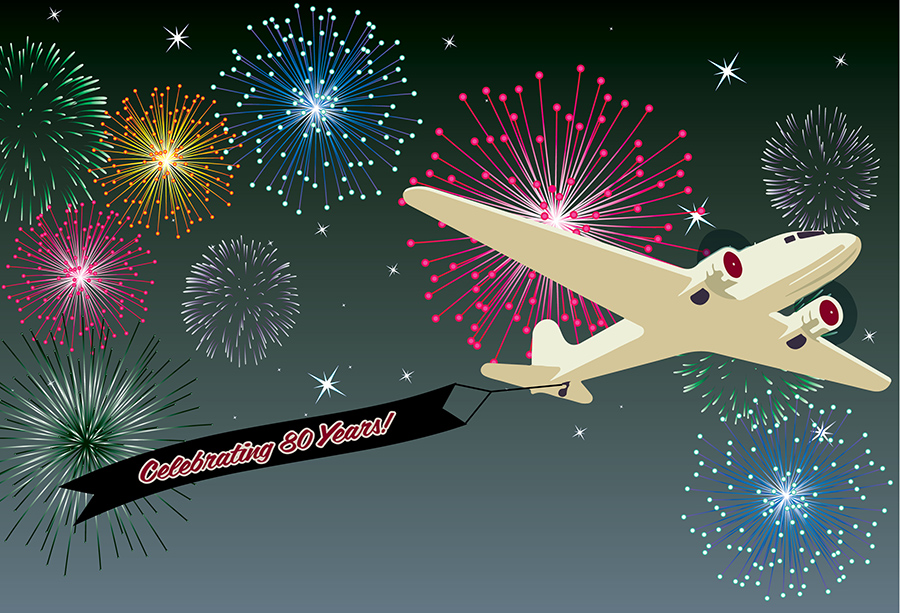Plane with banner Celebrating 80 years wih fireworks in the background